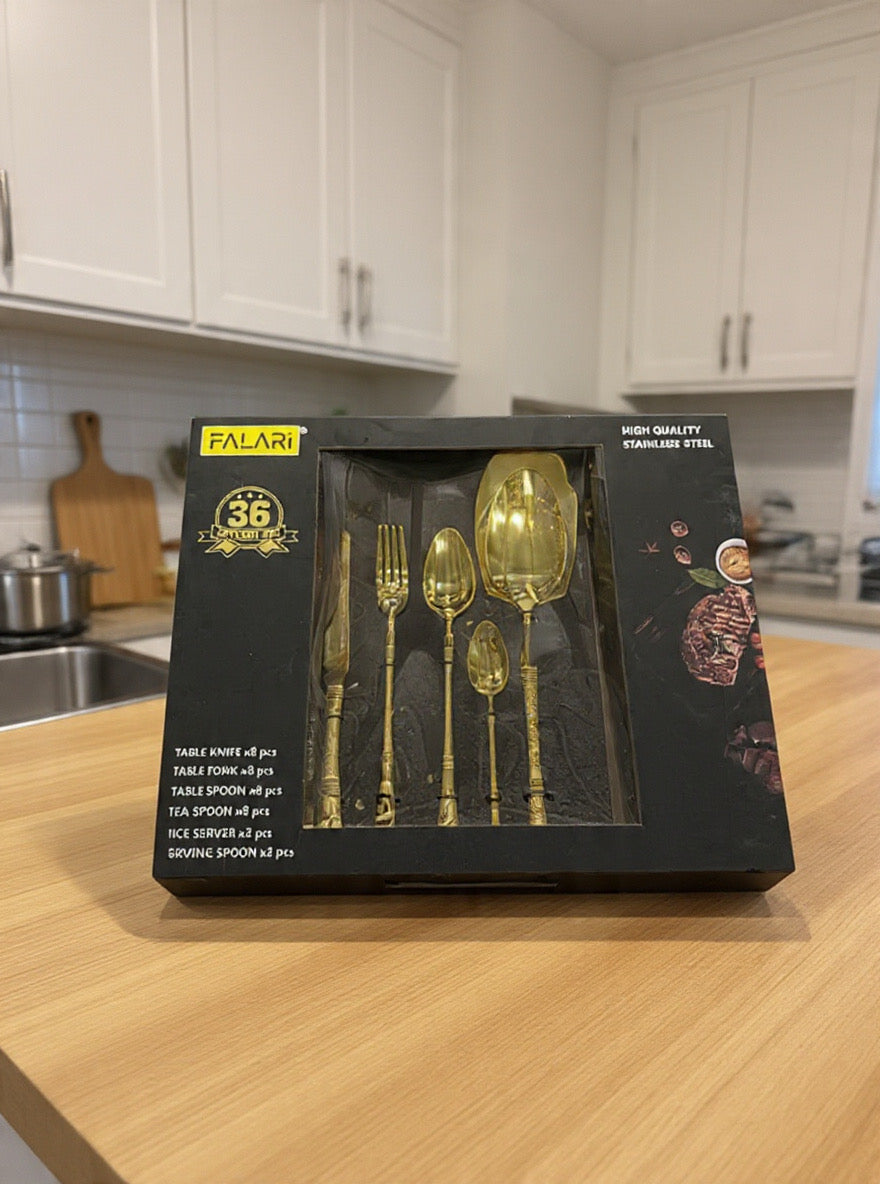 Falari 36-piece golden stainless steel cutlery set, which includes serving pieces and is presented in a black gift box.