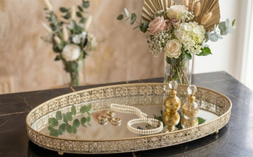 trendy handcrafted Craft Brio decorative tray features an oval glass mirror surrounded by a gold-plated filigree border.