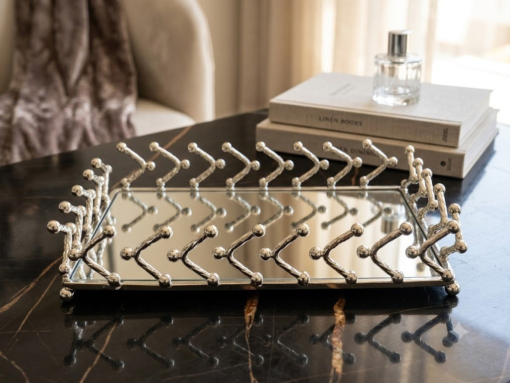This decorative rectangular vanity tray features a silver-plated frame with a modern geometric desig