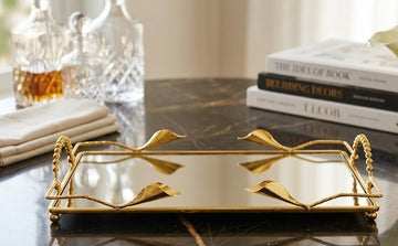 gilded Gala Flower Model mirror tray features decorative handles and a sleek, mirrored surface.